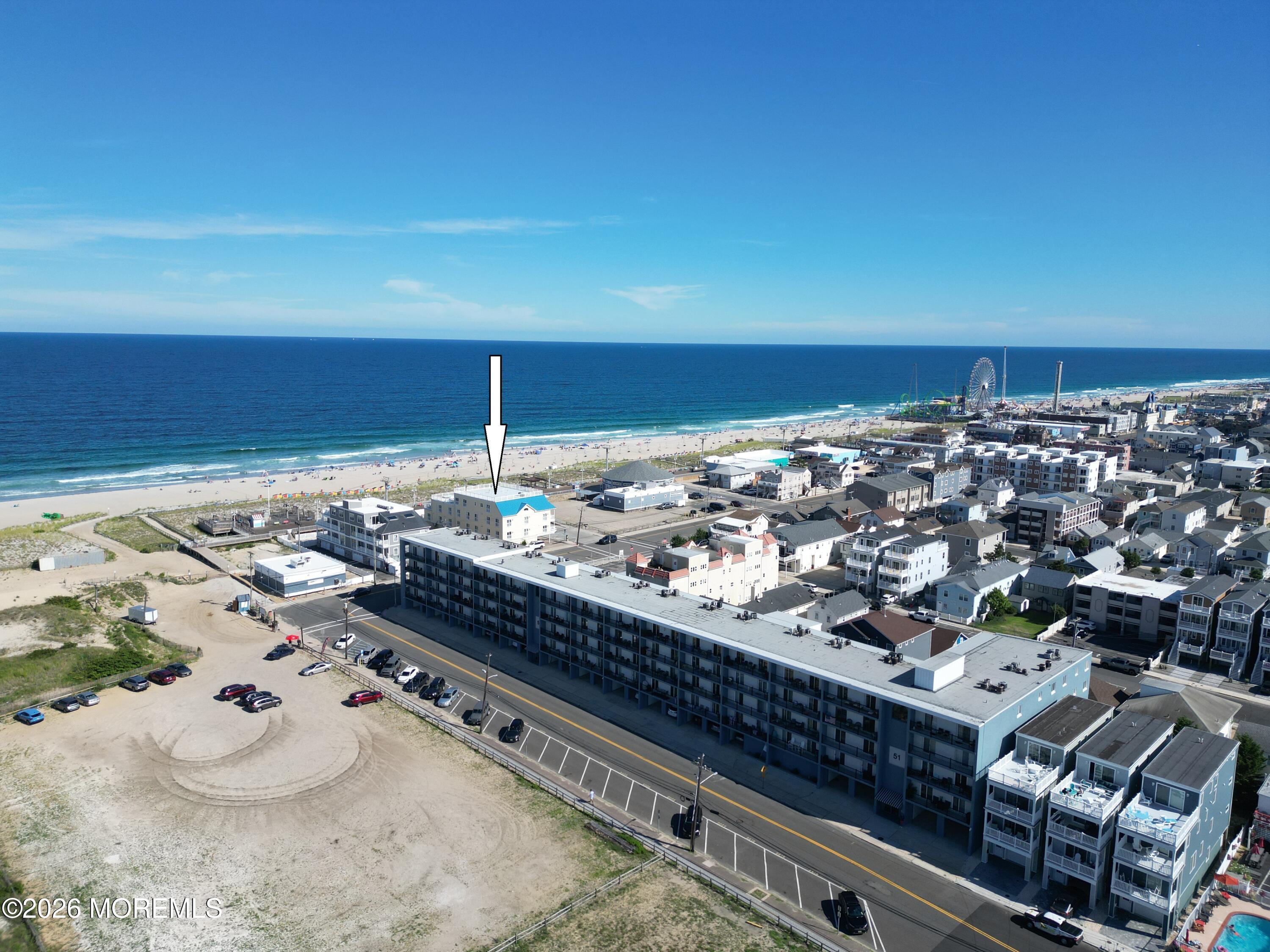 Aerial view of the marked beachfront property beside the sandy shore and Atlantic Ocean.