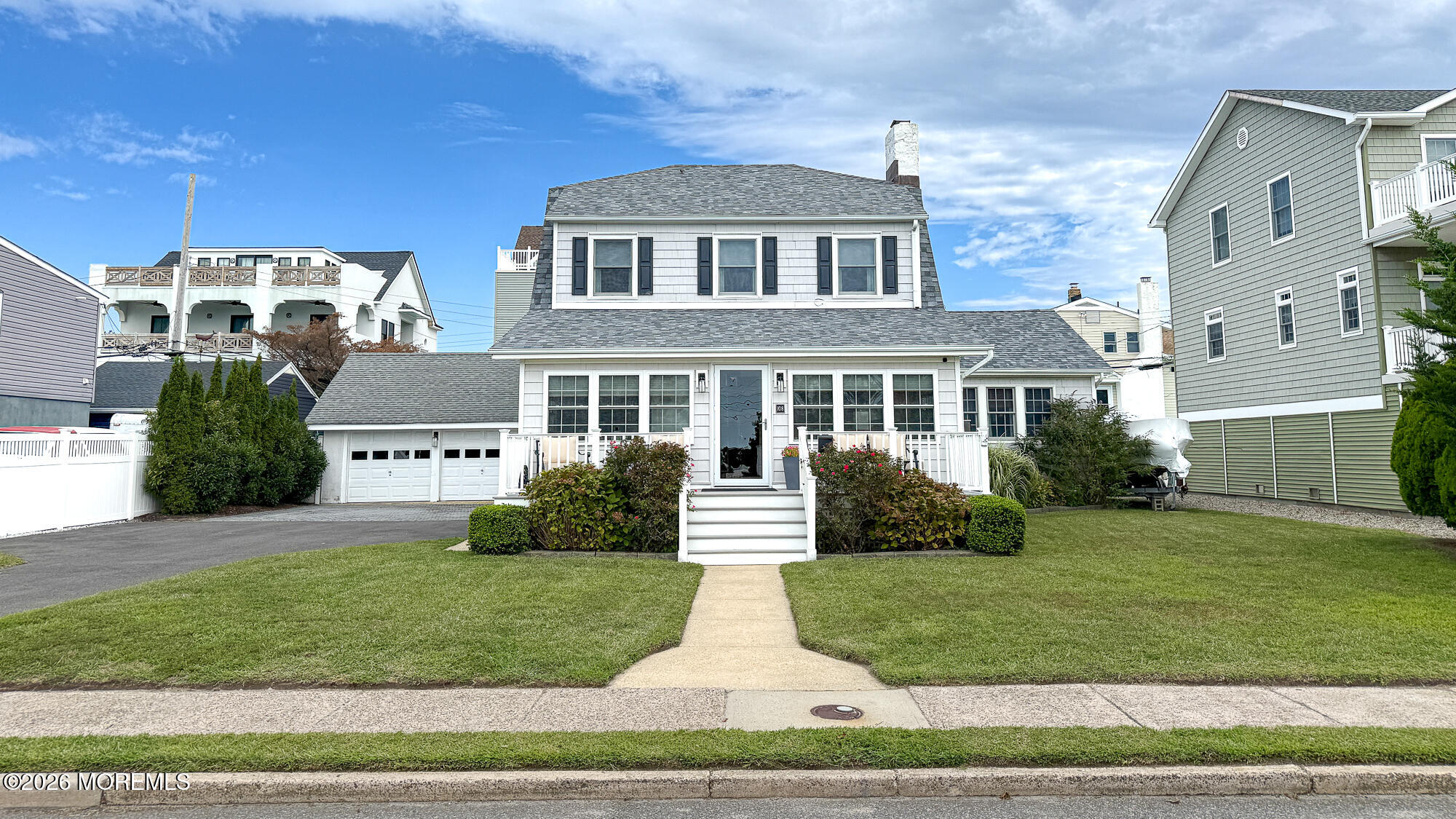 108 Roanoke Avenue, a gray-shingled two-story home with a white porch, double garage, and broad lawn.