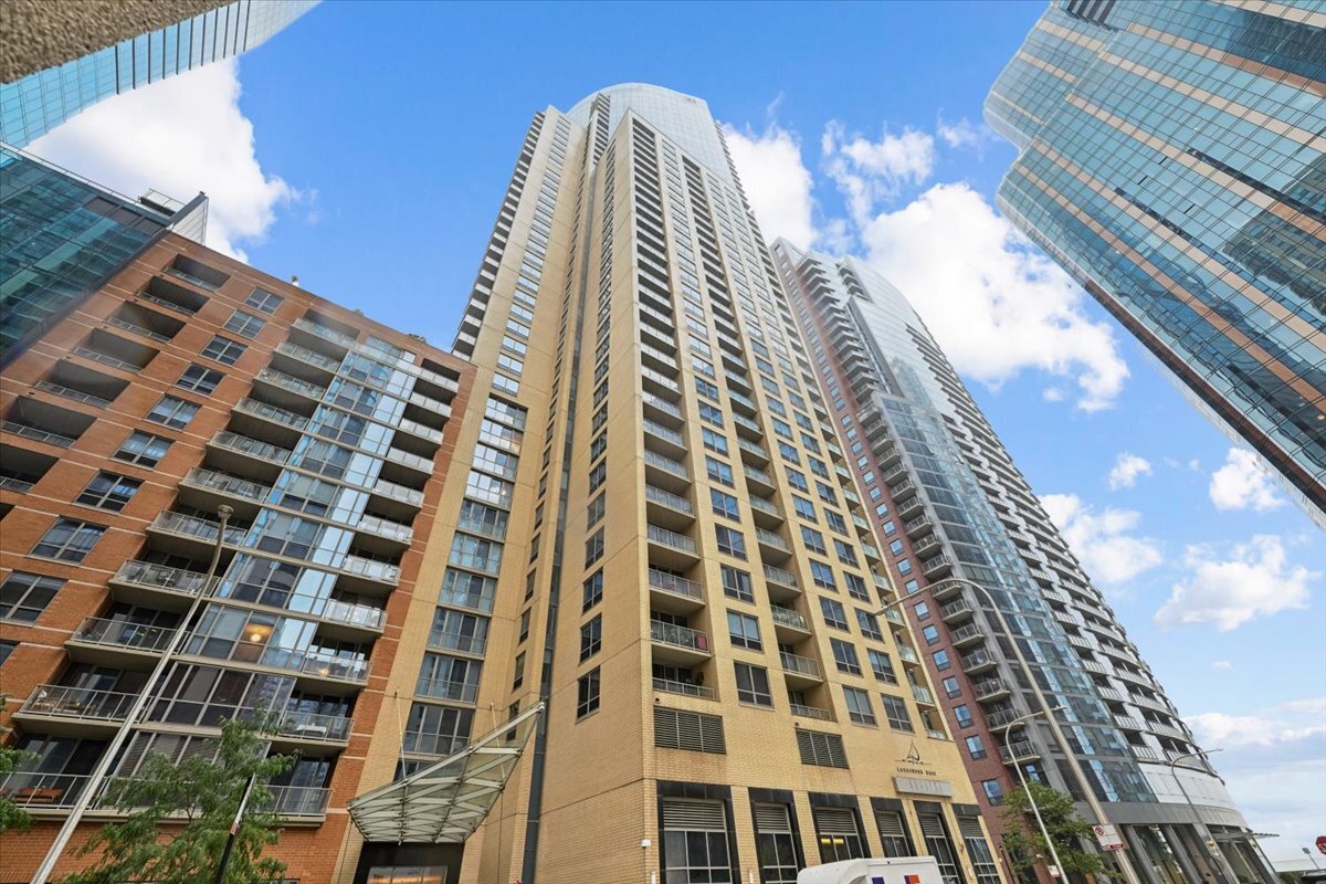 Modern Chicago condominium towers with glass facades and balconies, viewed from below.