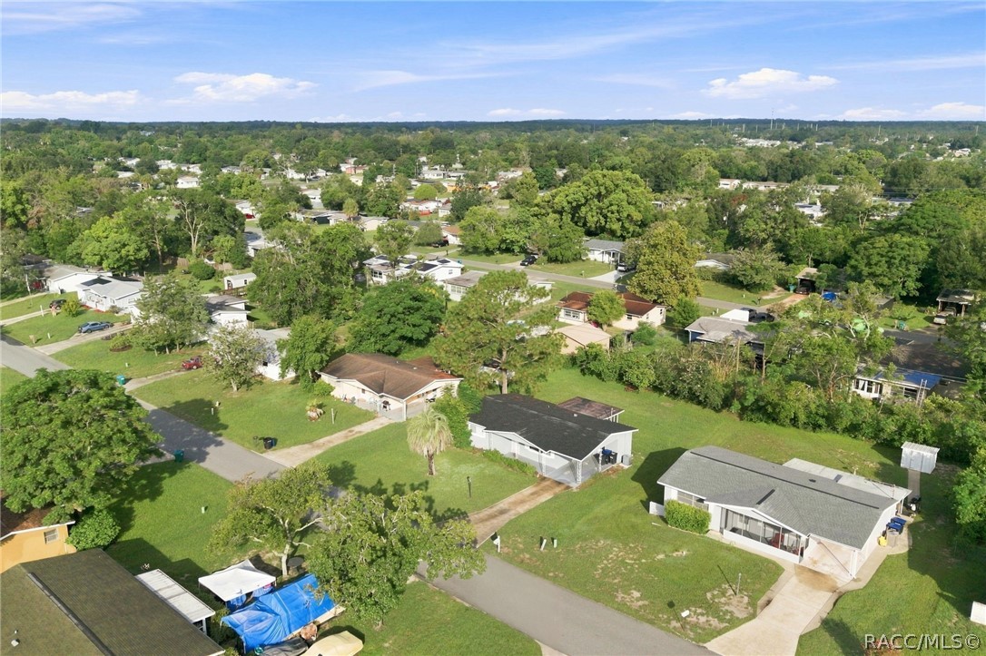 Aerial view of a leafy residential neighborhood with single-story homes and streets.