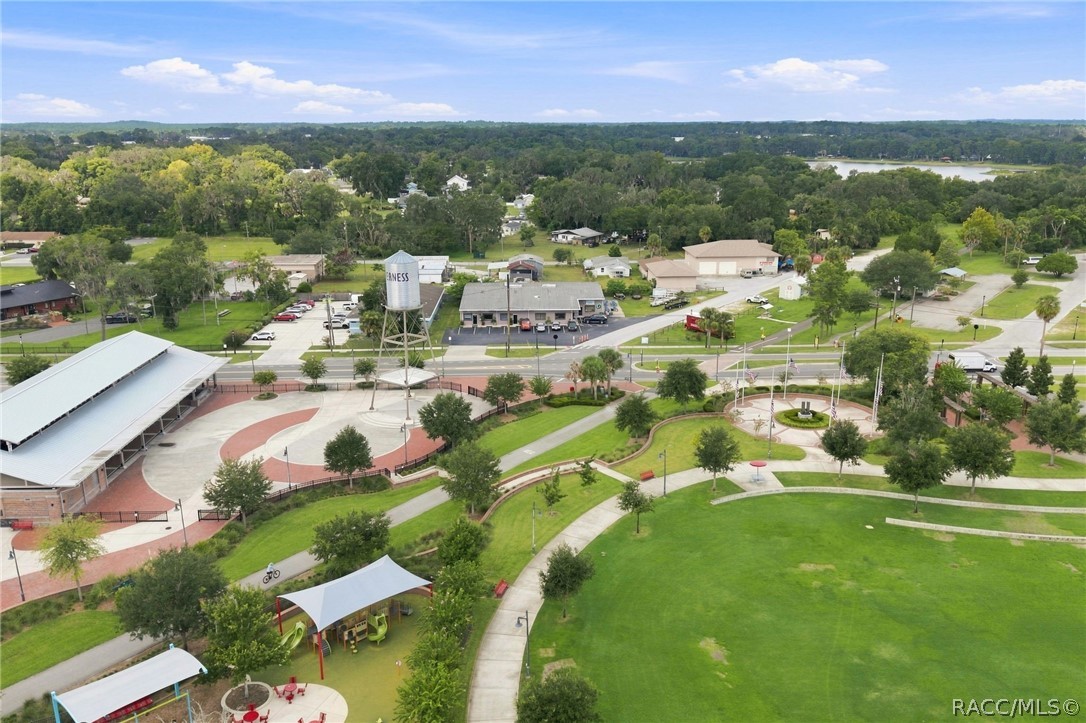 Aerial view of a landscaped park with walking paths, a playground, and a circular plaza.