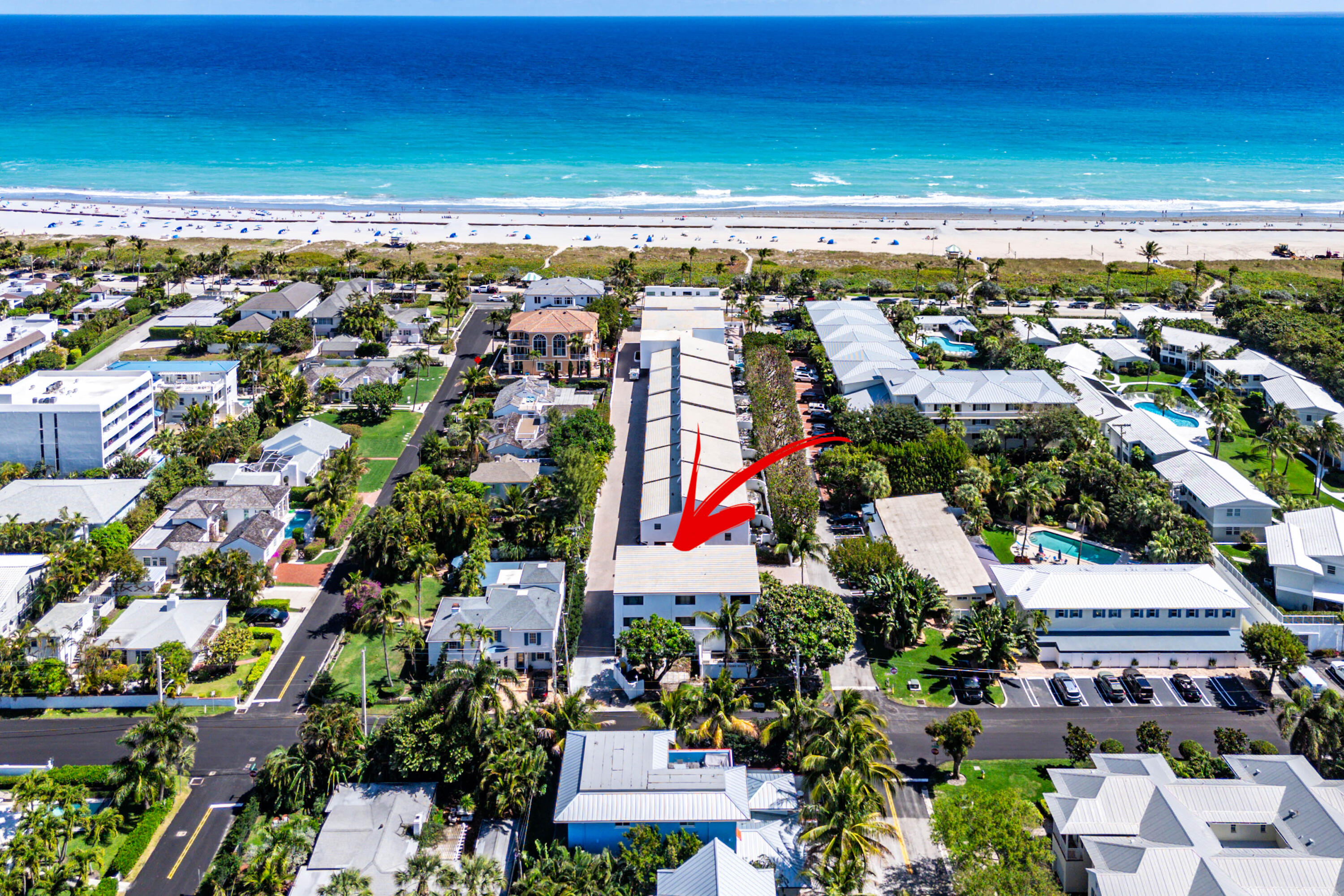 Aerial view of 250 S Ocean Boulevard near the beach, marked by a red arrow.