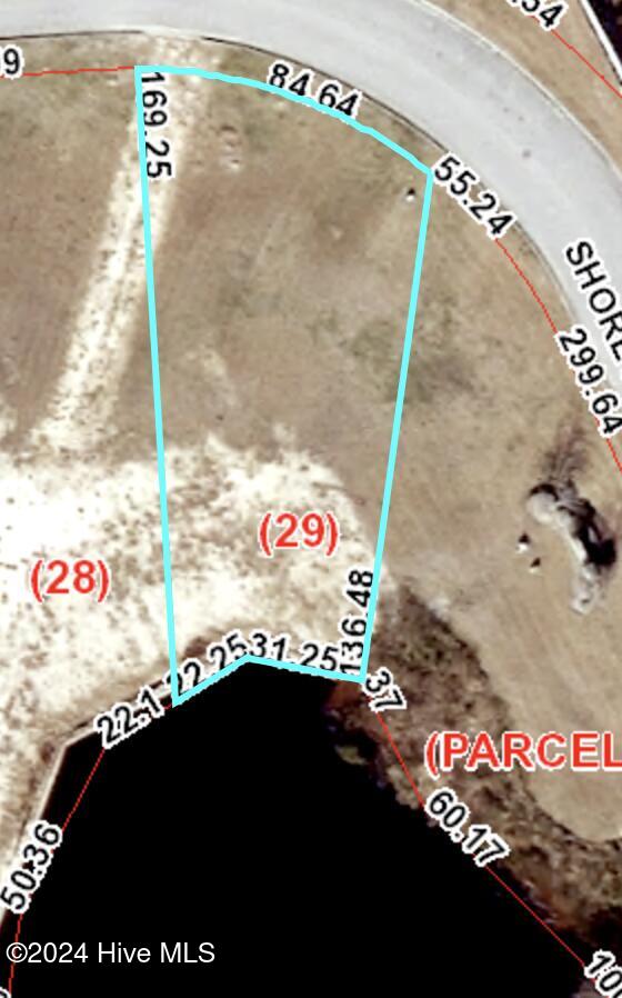 Aerial parcel map of lot 29 outlined beside the water, with boundary measurements.