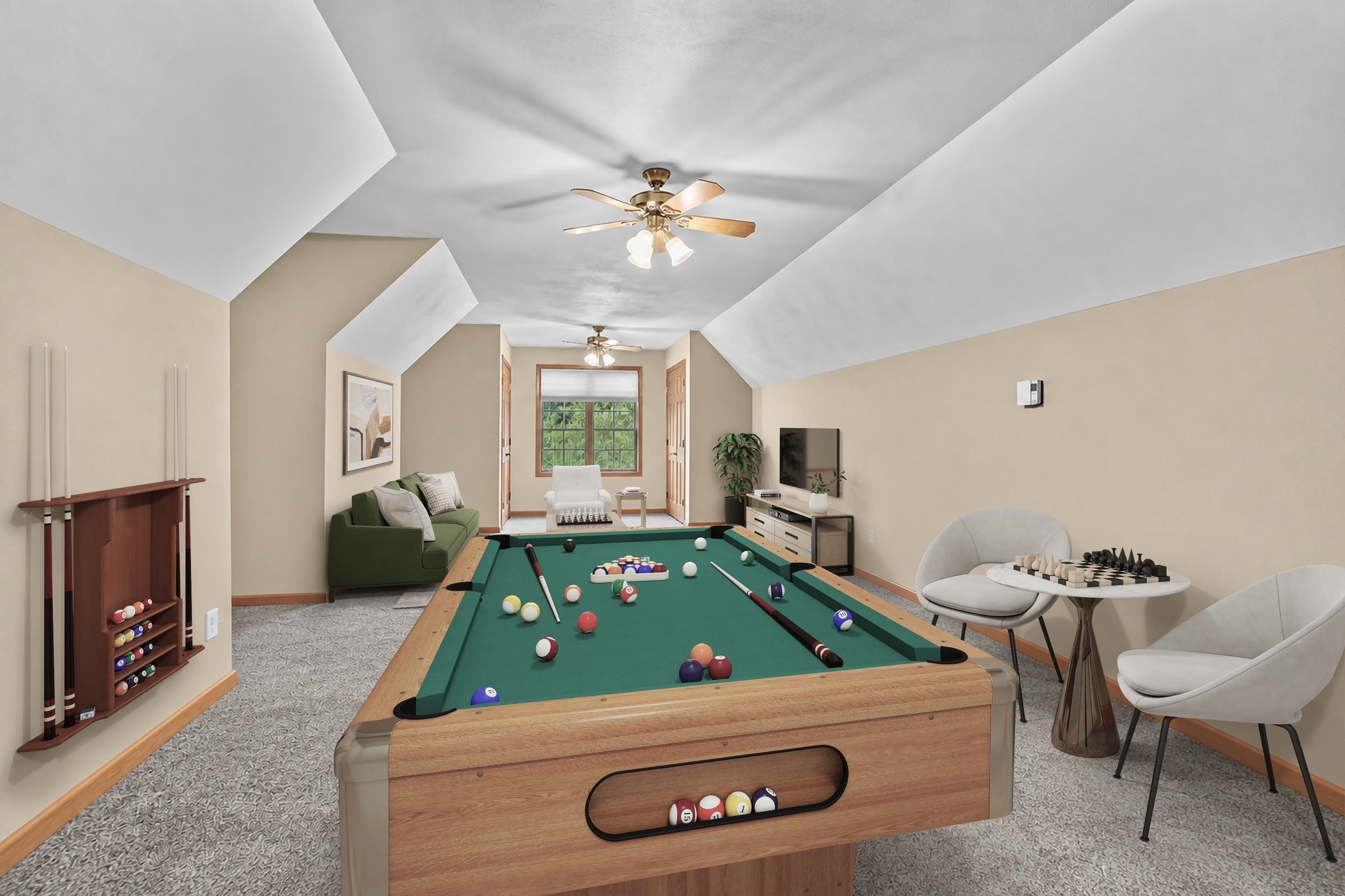 Game room with a pool table beneath a sloped ceiling, plus a sofa and chess table.