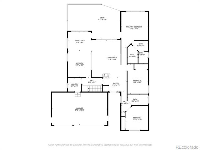 Floor plan of a home with three bedrooms, a garage, open living areas, and a deck.