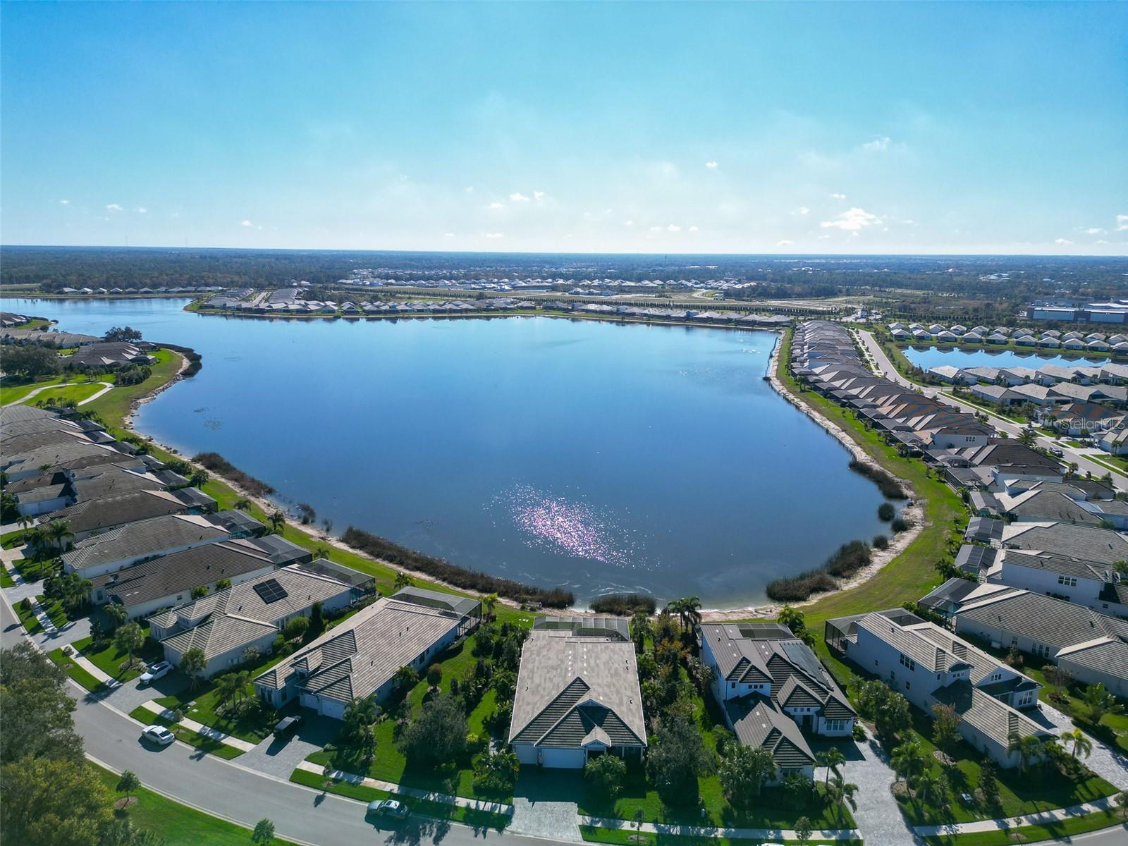 Aerial view of homes surrounding a large lake in a residential community.