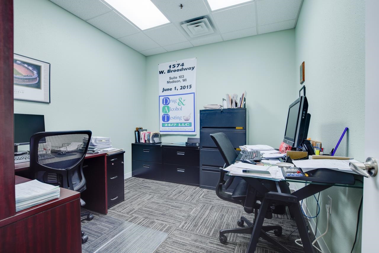 Furnished office with desks, filing cabinets, and a sign for Drug & Alcohol Testing 24/7 LLC.
