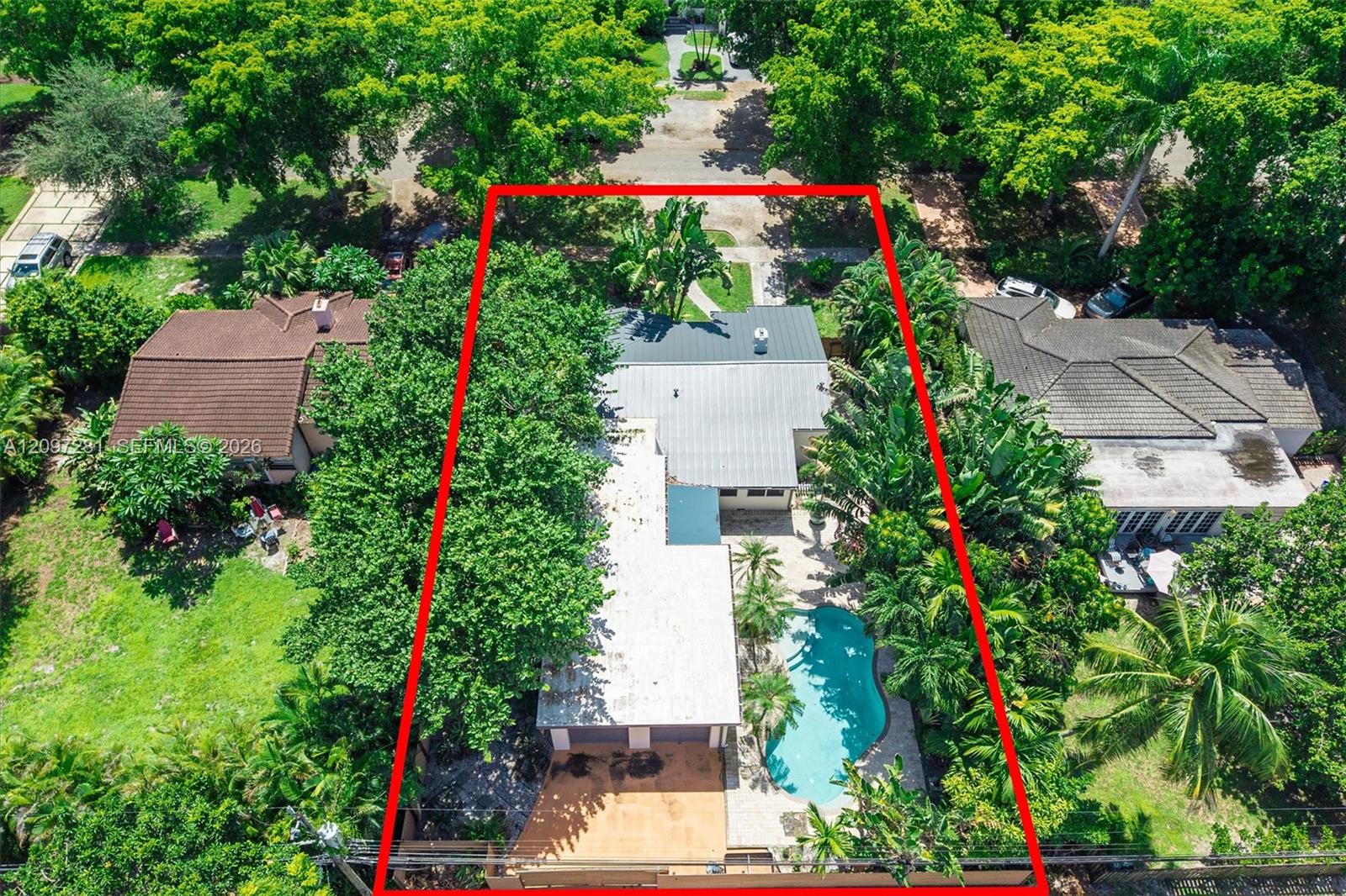 Aerial view of a Miami Shores home and pool, with the property outlined in red.