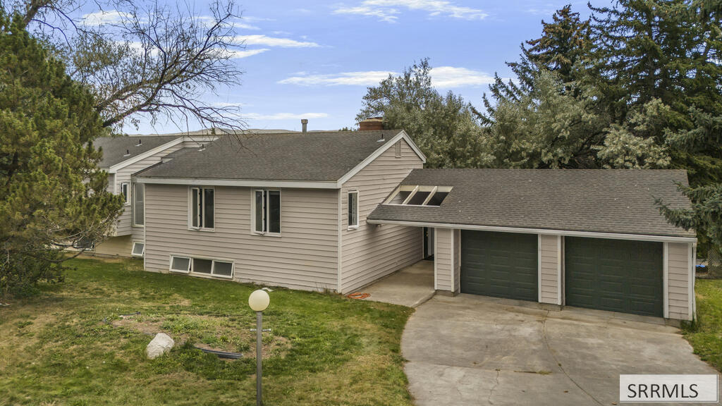 Beige two-story house with an attached double garage and concrete driveway