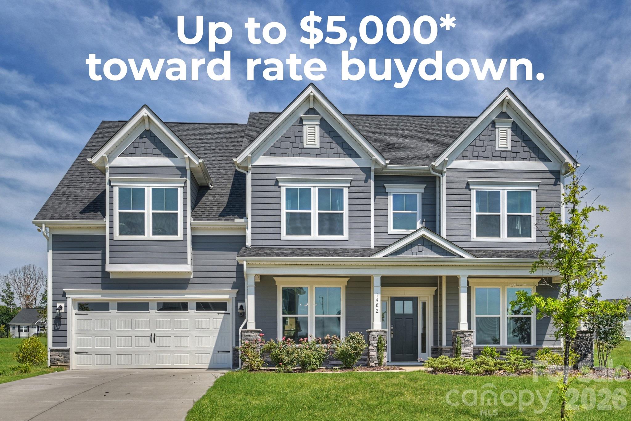 Rate buydown offer of up to $5,000 over a two-story gray house.
