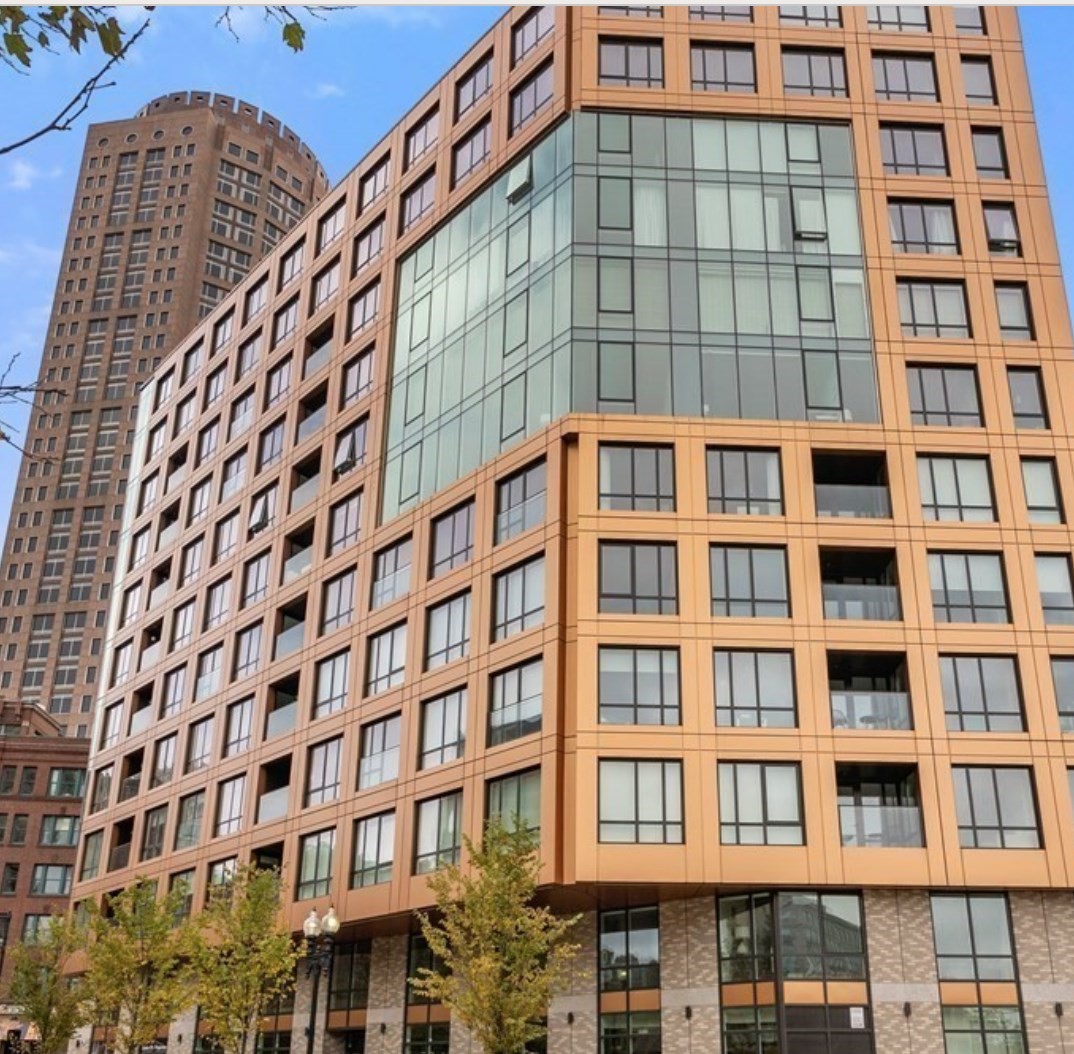 110 Broad Street residential building with a tan-orange facade and glass corner in Boston.