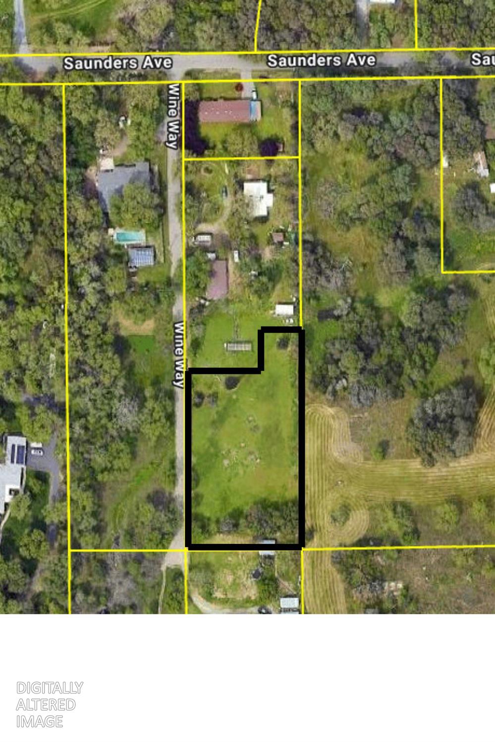 Aerial view of a grassy parcel outlined in black beside Wine Way, surrounded by trees and neighboring properties.