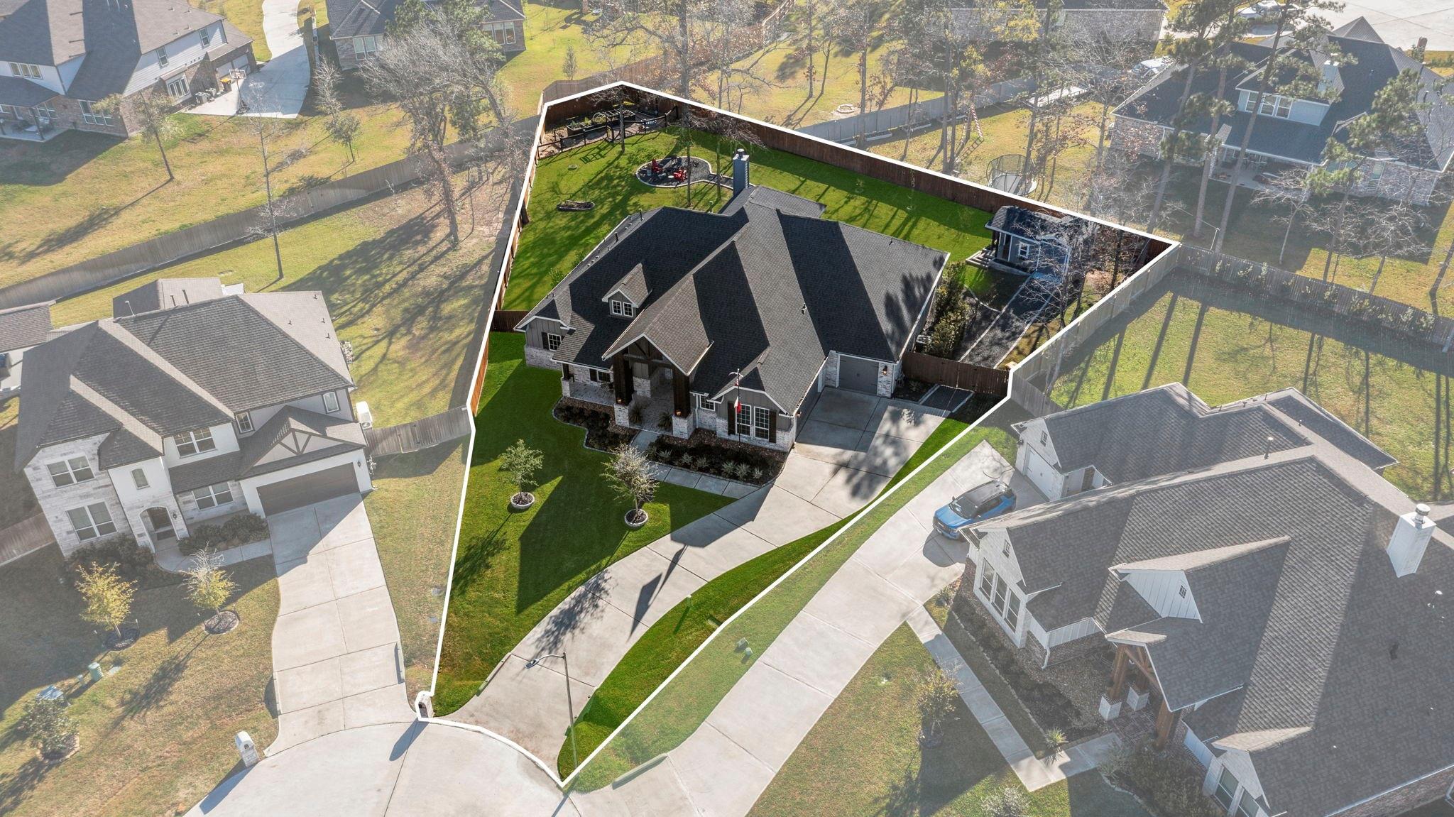 Aerial view of a home and its fenced lot, with a backyard playset and landscaped front lawn.