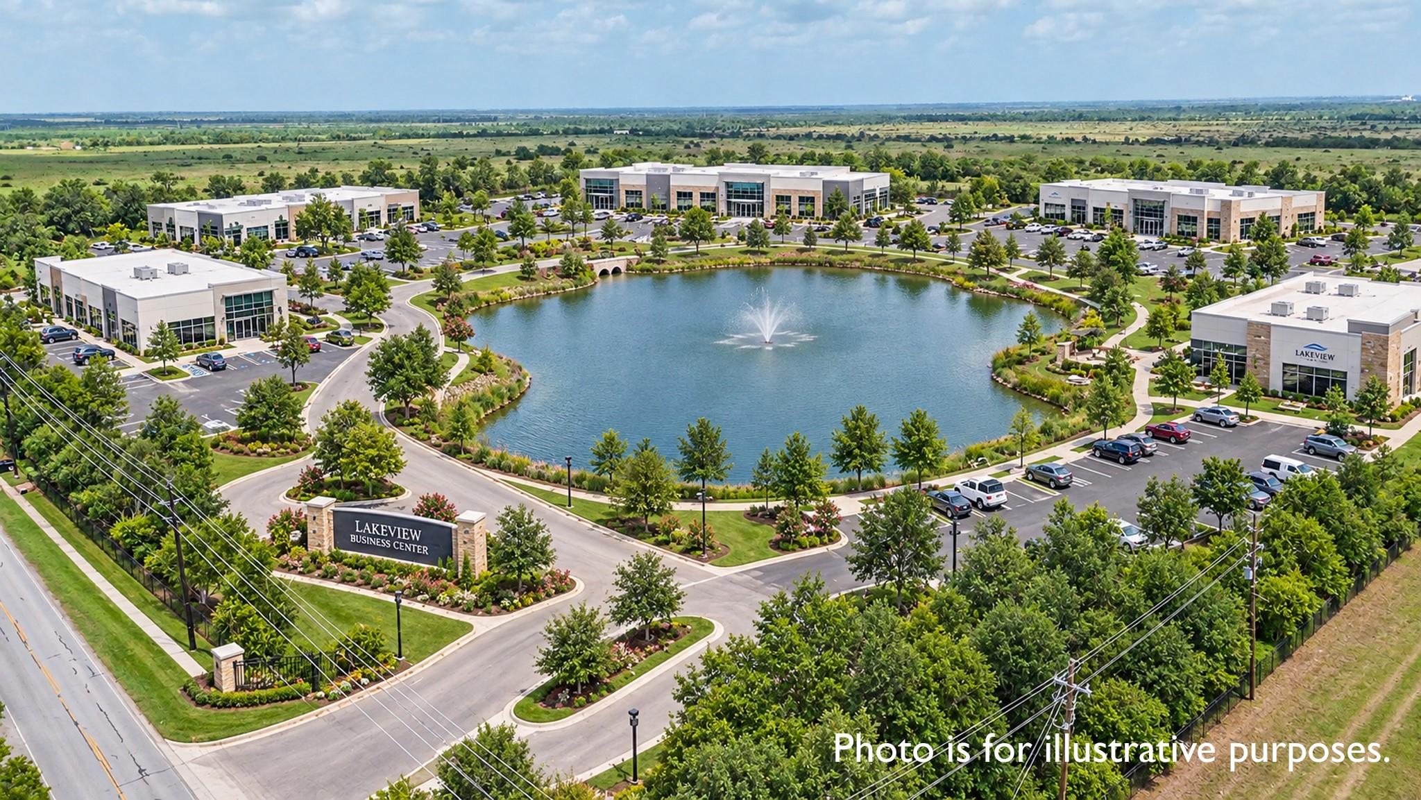 Aerial view of Lakeview Business Center around a landscaped pond with a fountain and parking lots.