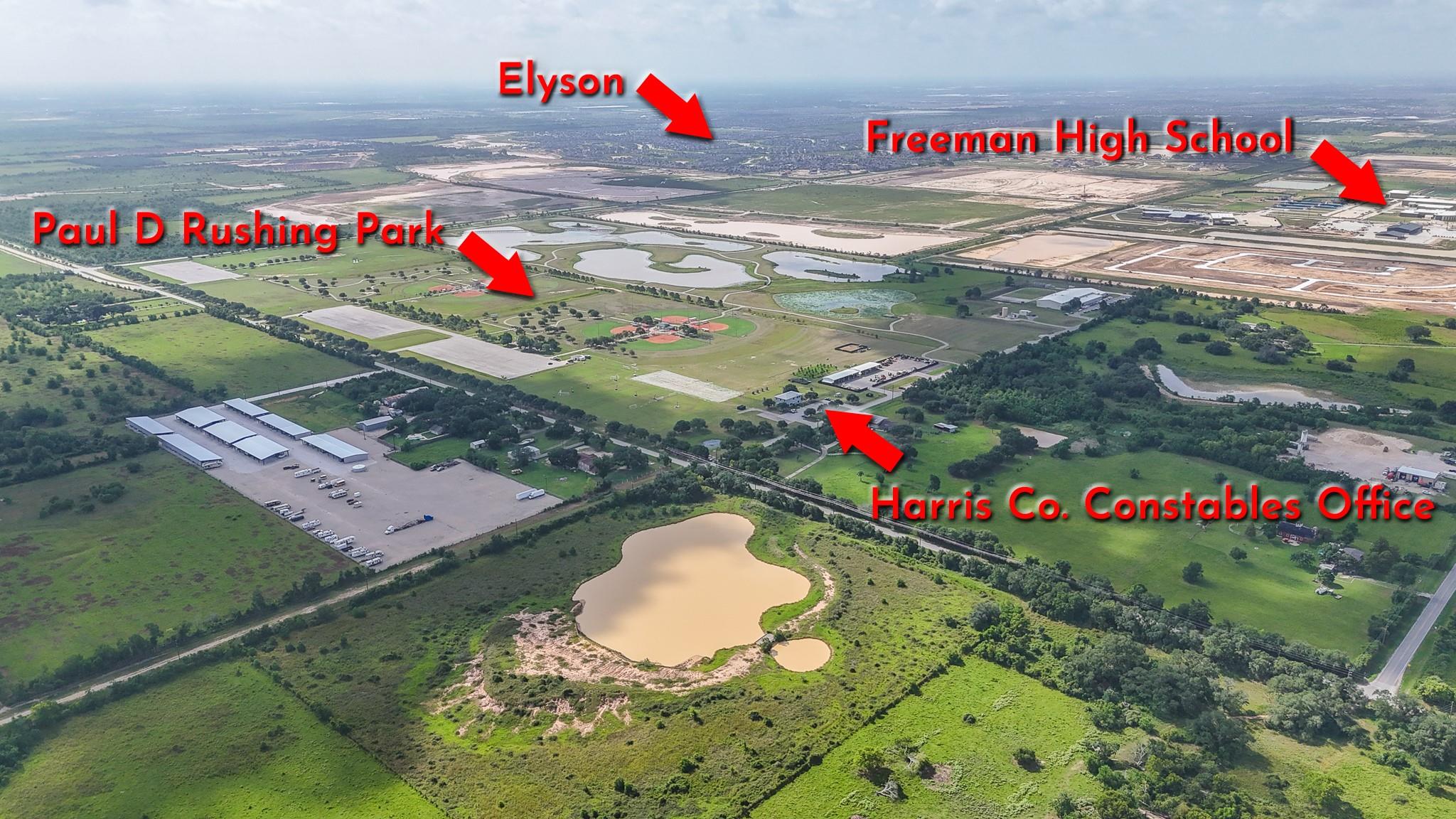 Aerial view of green acreage and ponds near Paul D Rushing Park and Freeman High School.