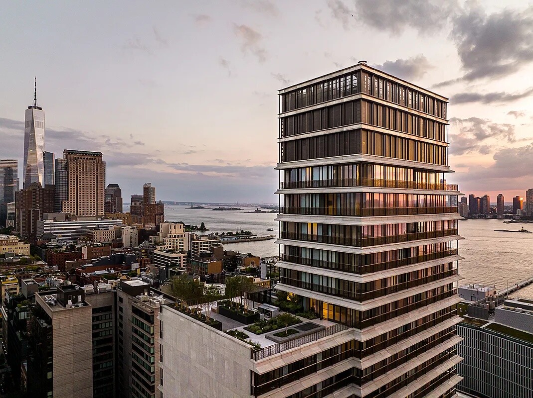 100 Vandam Street tower overlooking the Hudson River and downtown Manhattan at sunset.