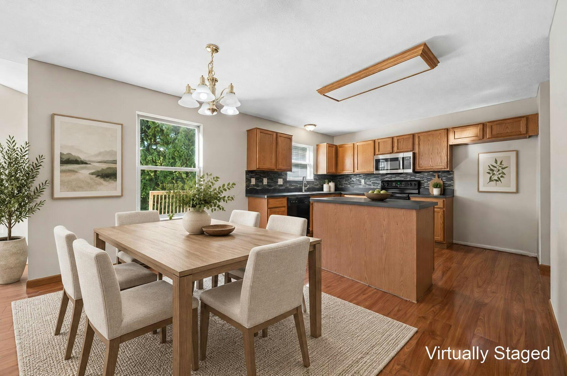 Virtually staged kitchen and dining area with wood cabinets and a large dining table.