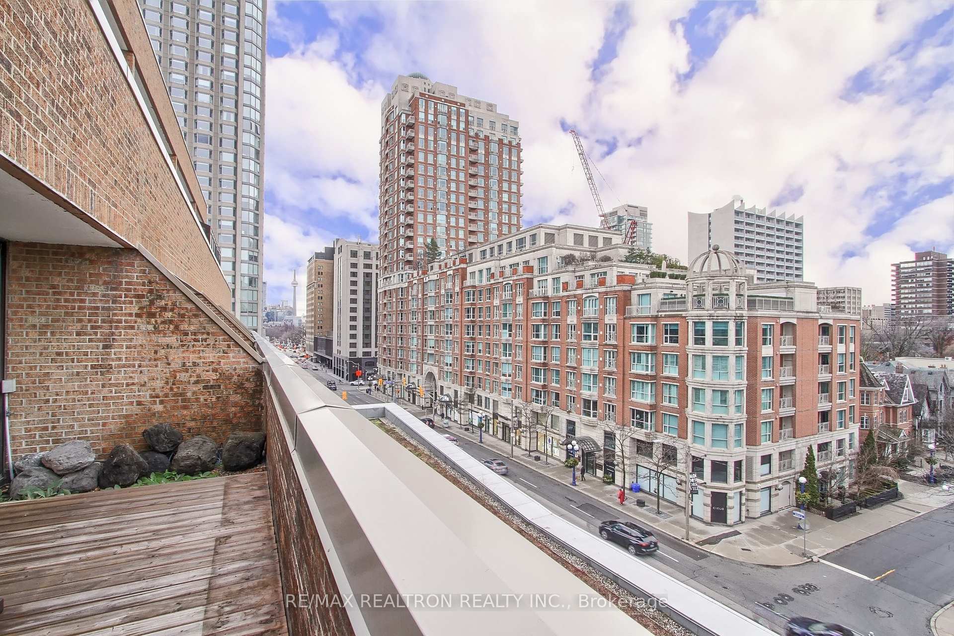 Balcony overlooking Toronto’s high-rise buildings and a busy street.