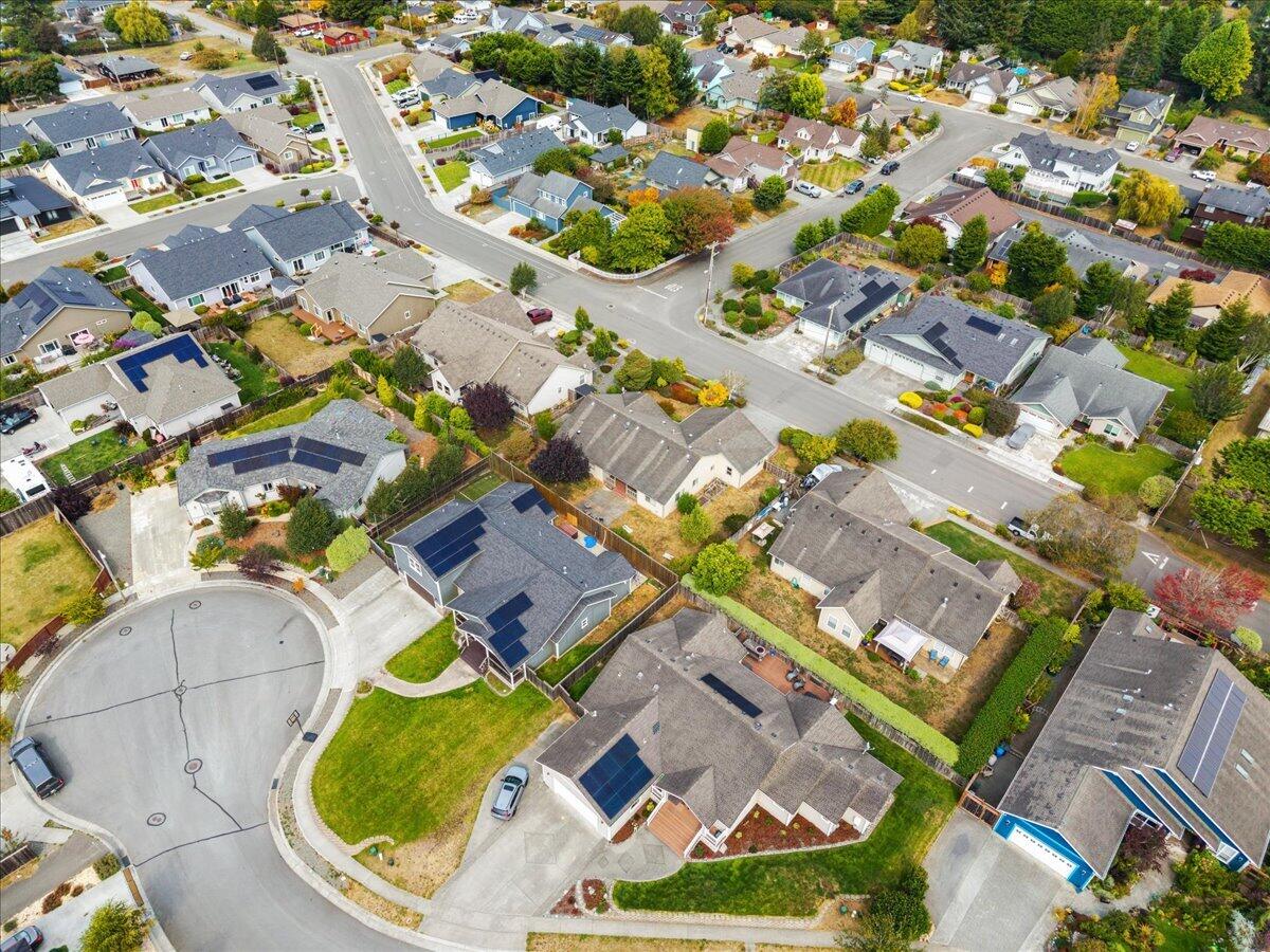 Aerial view of a McKinleyville neighborhood with a cul-de-sac, detached homes, and solar panels.