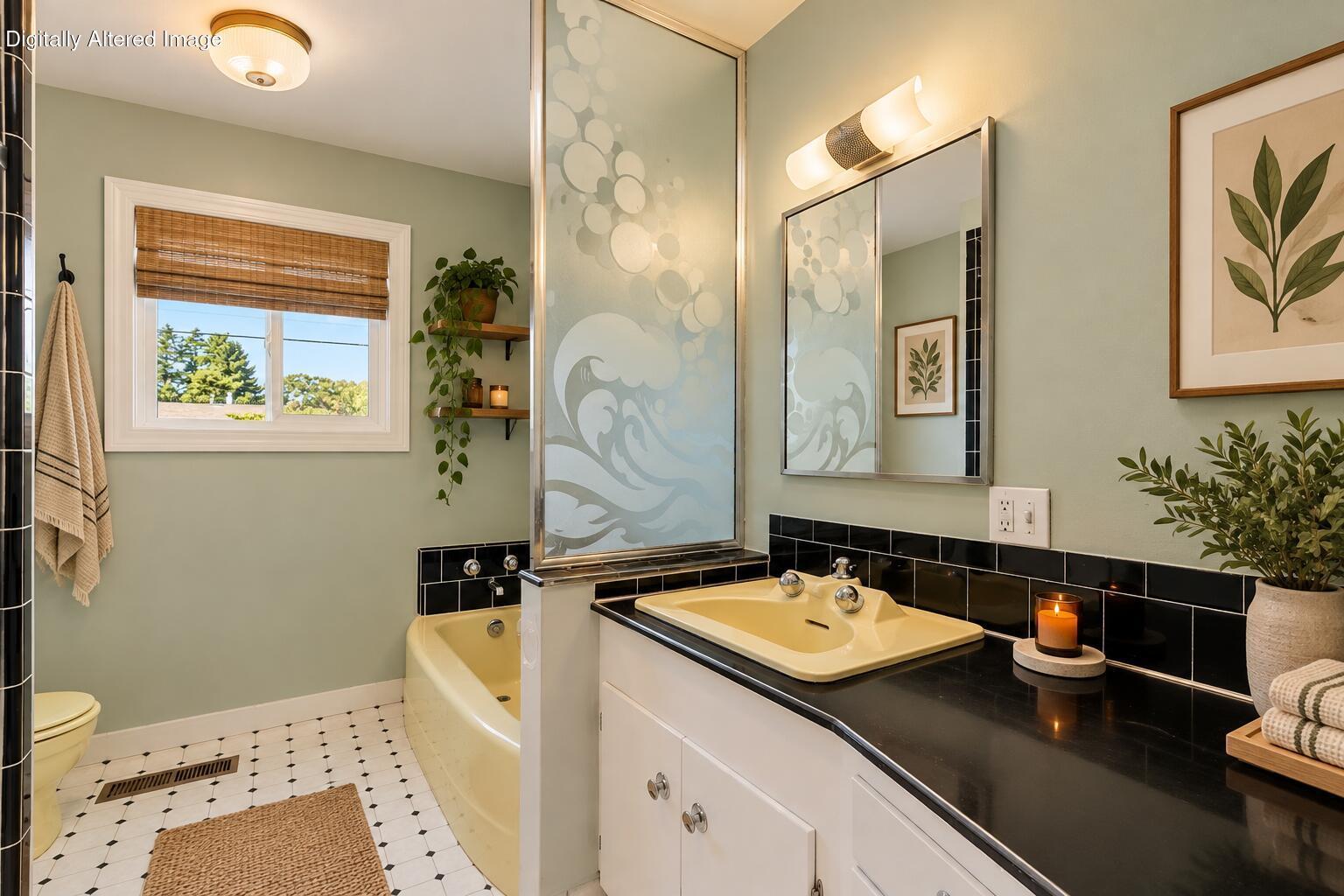 Bathroom with a bathtub, patterned glass shower screen, and vanity with a glossy black countertop.