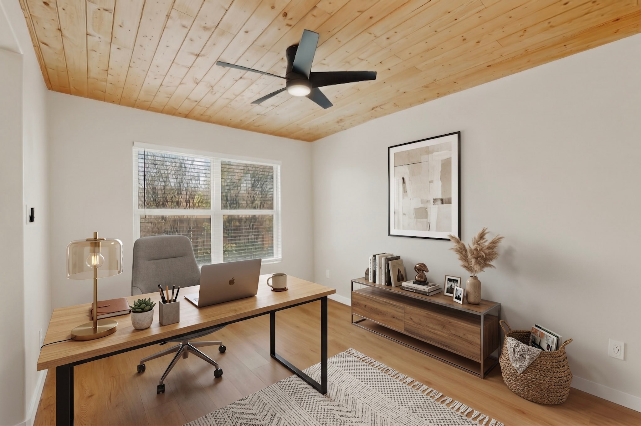 Home office with a wood-plank ceiling, desk, laptop, and large window.