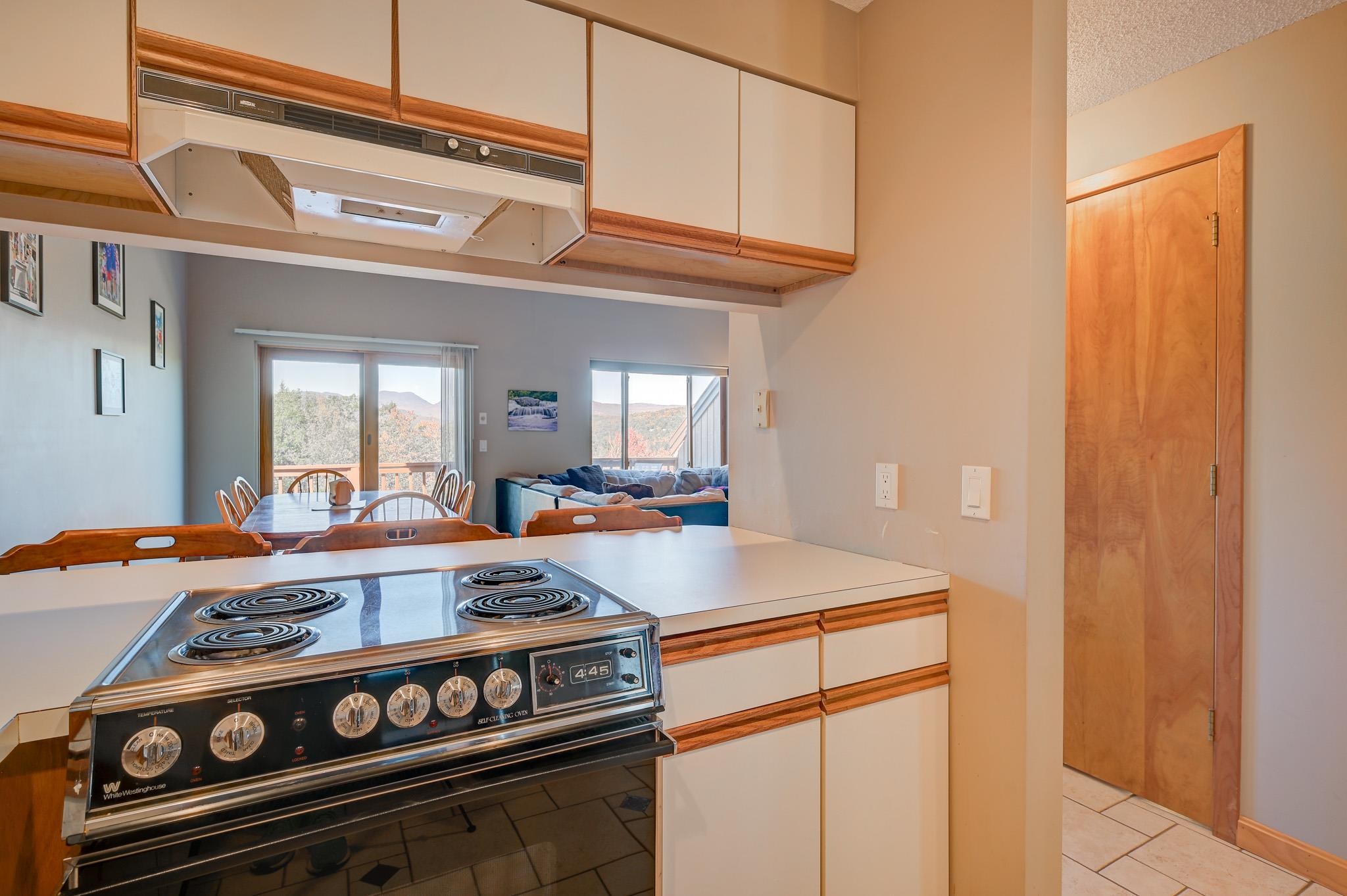 Kitchen with a vintage White Westinghouse range, dining area, and mountain views through the windows.
