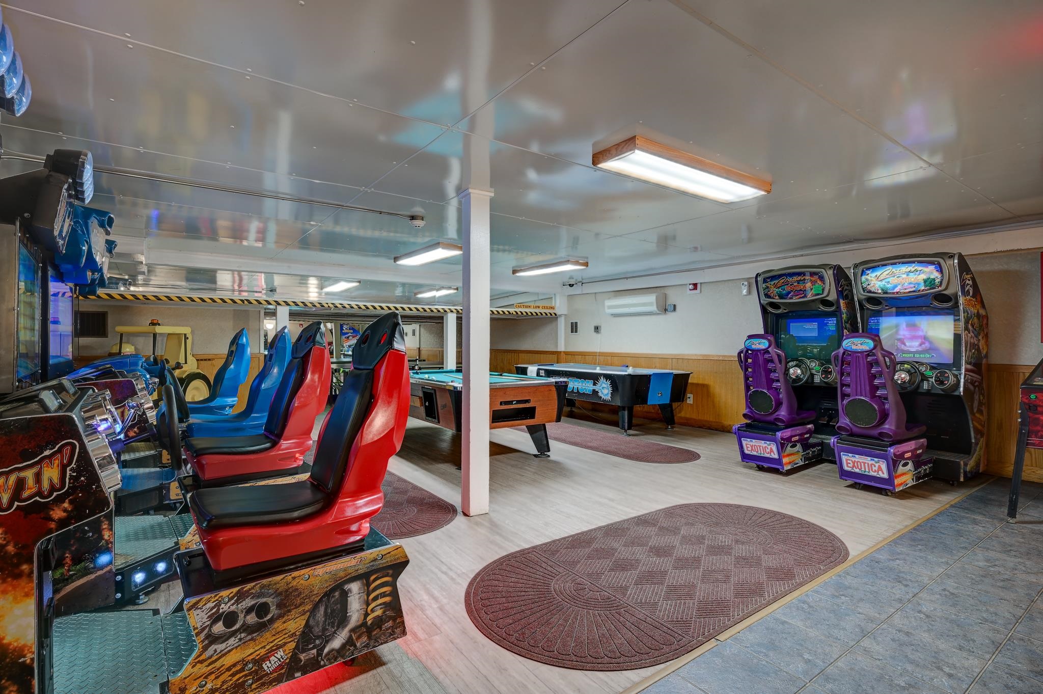 Recreation room with arcade racing games, Exotica machines, and pool tables.