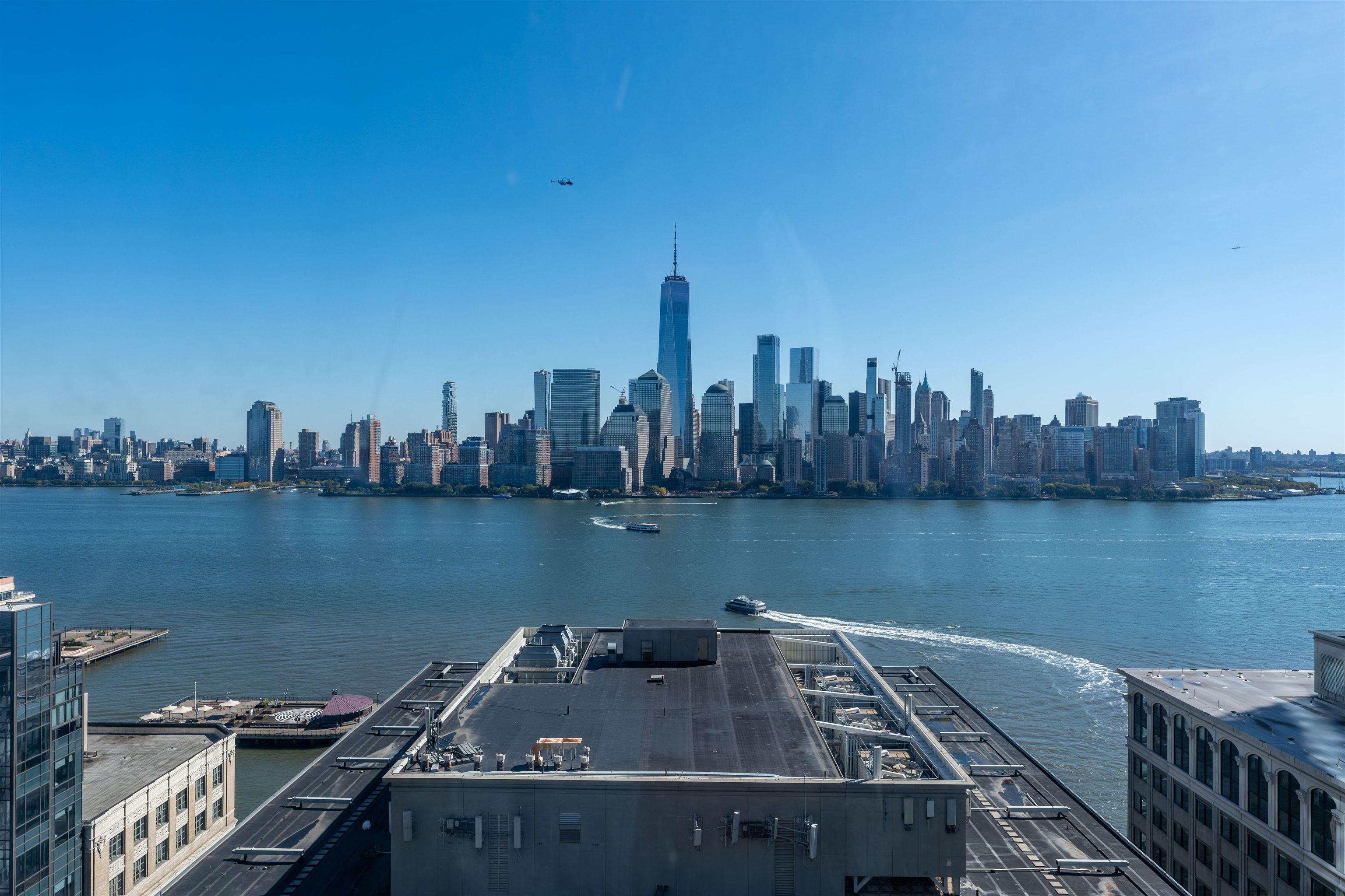 Hudson River and Lower Manhattan skyline with One World Trade Center across the water.
