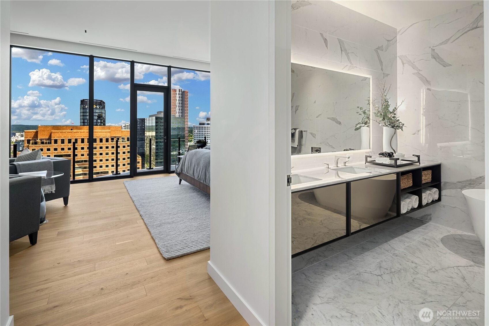 Bedroom and marble bathroom with floor-to-ceiling windows overlooking the Bellevue skyline.