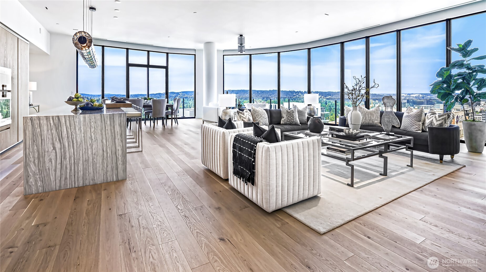 Staged condo living room and kitchen with floor-to-ceiling windows and views of Bellevue.