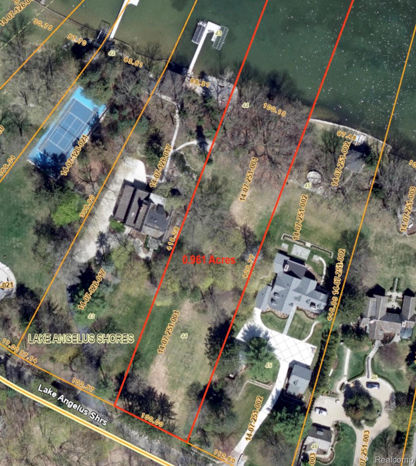 Aerial view of a 0.961-acre lakeside lot outlined in red beside Lake Angelus.