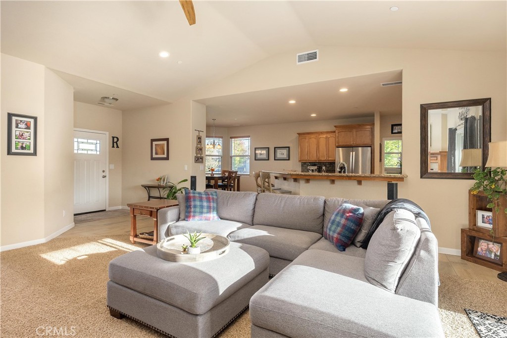Furnished living room with a large gray sectional and an open view into the kitchen.