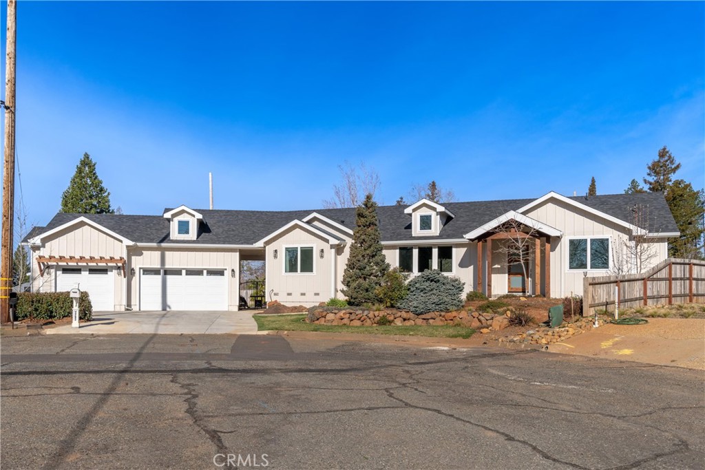 Single-story home with two garage bays, roof dormers, and a covered entry.
