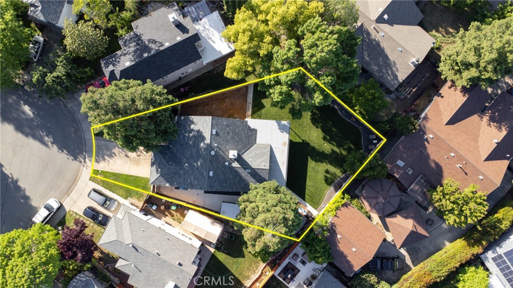 Aerial view of a house and landscaped yard outlined in yellow.