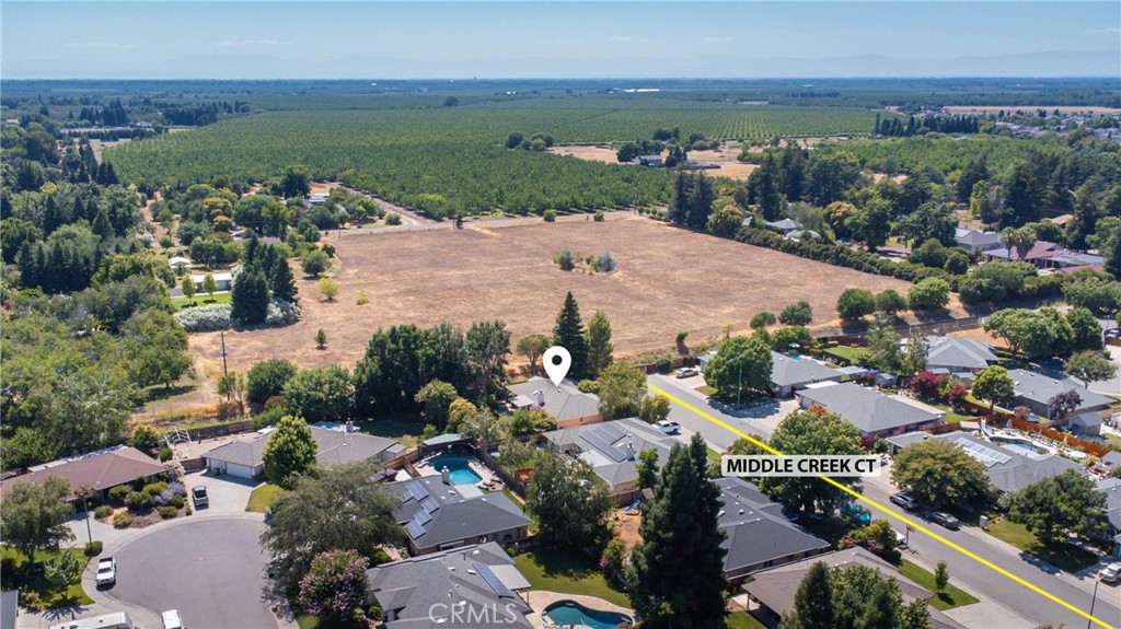 Aerial view of homes along Middle Creek Court beside a large open field.