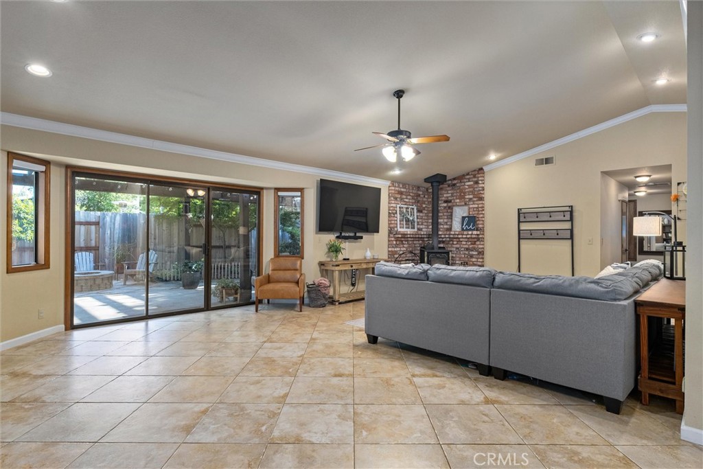 Living room with gray sectional, brick fireplace, and sliding glass doors to a patio.
