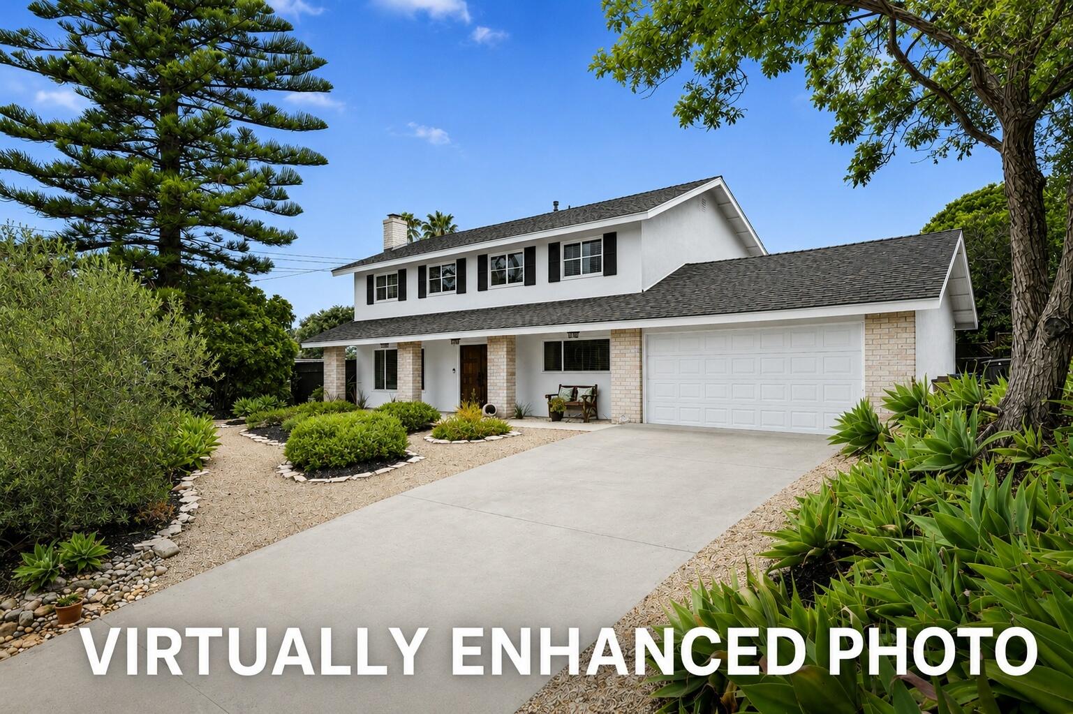 Two-story white house with dark shutters, a two-car garage, and landscaped gravel beds along the driveway.