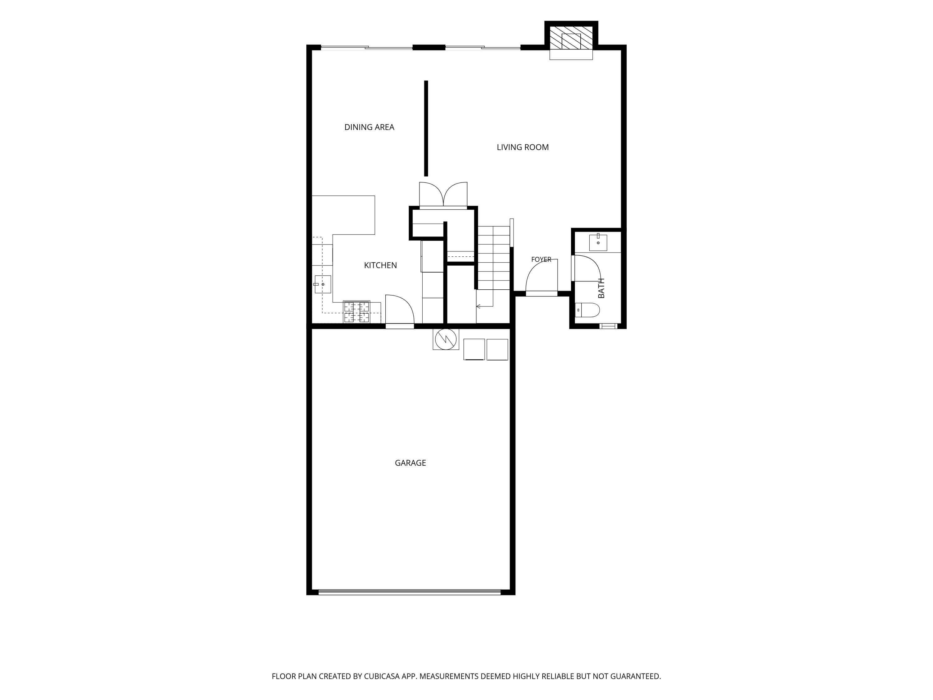 Floor plan showing kitchen, dining area, living room, foyer, bath, stairs, and garage.