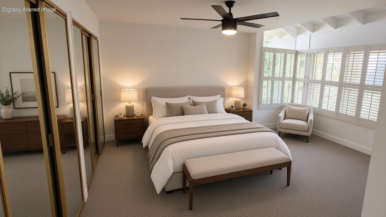 Bedroom with a large bed, mirrored closet doors, and bright shuttered windows.