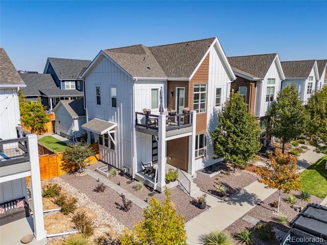Modern attached homes with gabled roofs, balconies, and autumn landscaping.