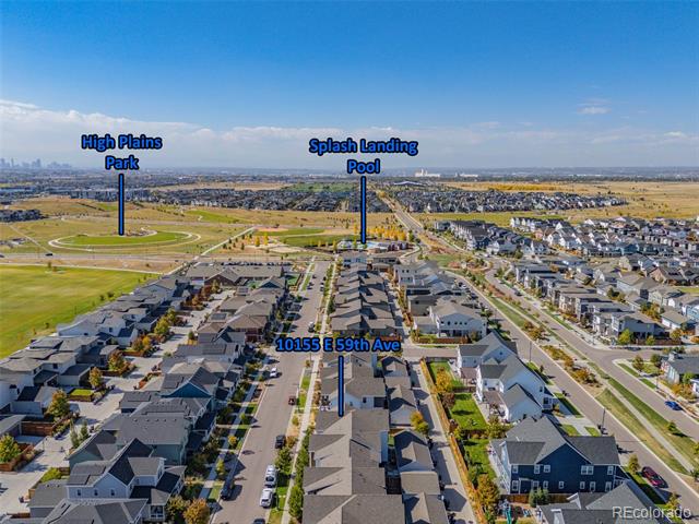 Aerial view of 10155 E 59th Avenue, with nearby High Plains Park and Splash Landing Pool labeled.