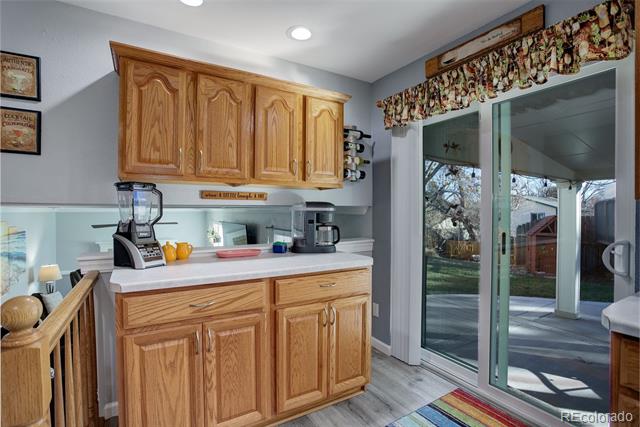 Kitchen with oak cabinets and sliding glass doors opening to a patio.