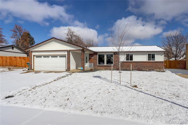 Single-story brick-and-siding house with an attached garage and snow-covered front yard.