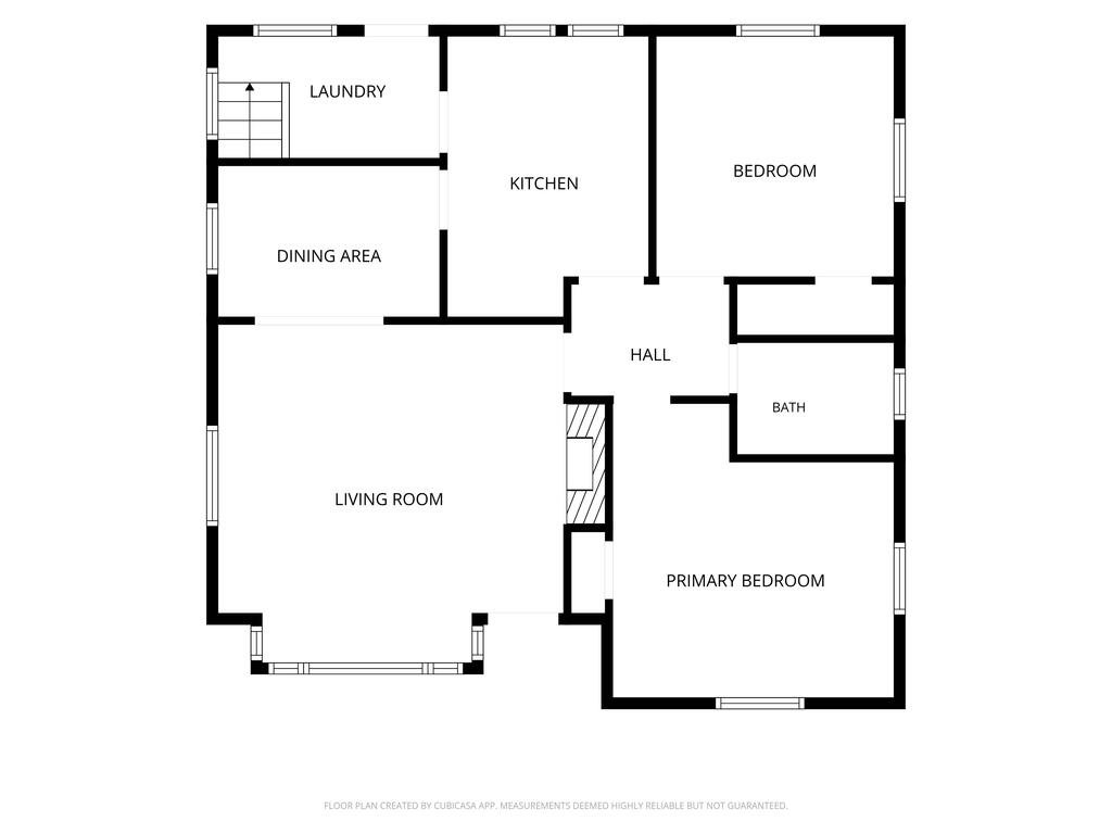 Floor plan showing a living room, dining area, kitchen, laundry room, two bedrooms, primary bedroom, bath, and hall.
