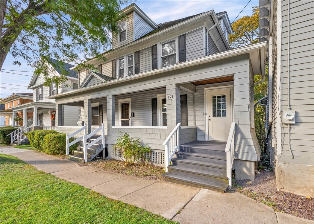 Gray two-story homes with covered porches and white railings along Pulteney Street.