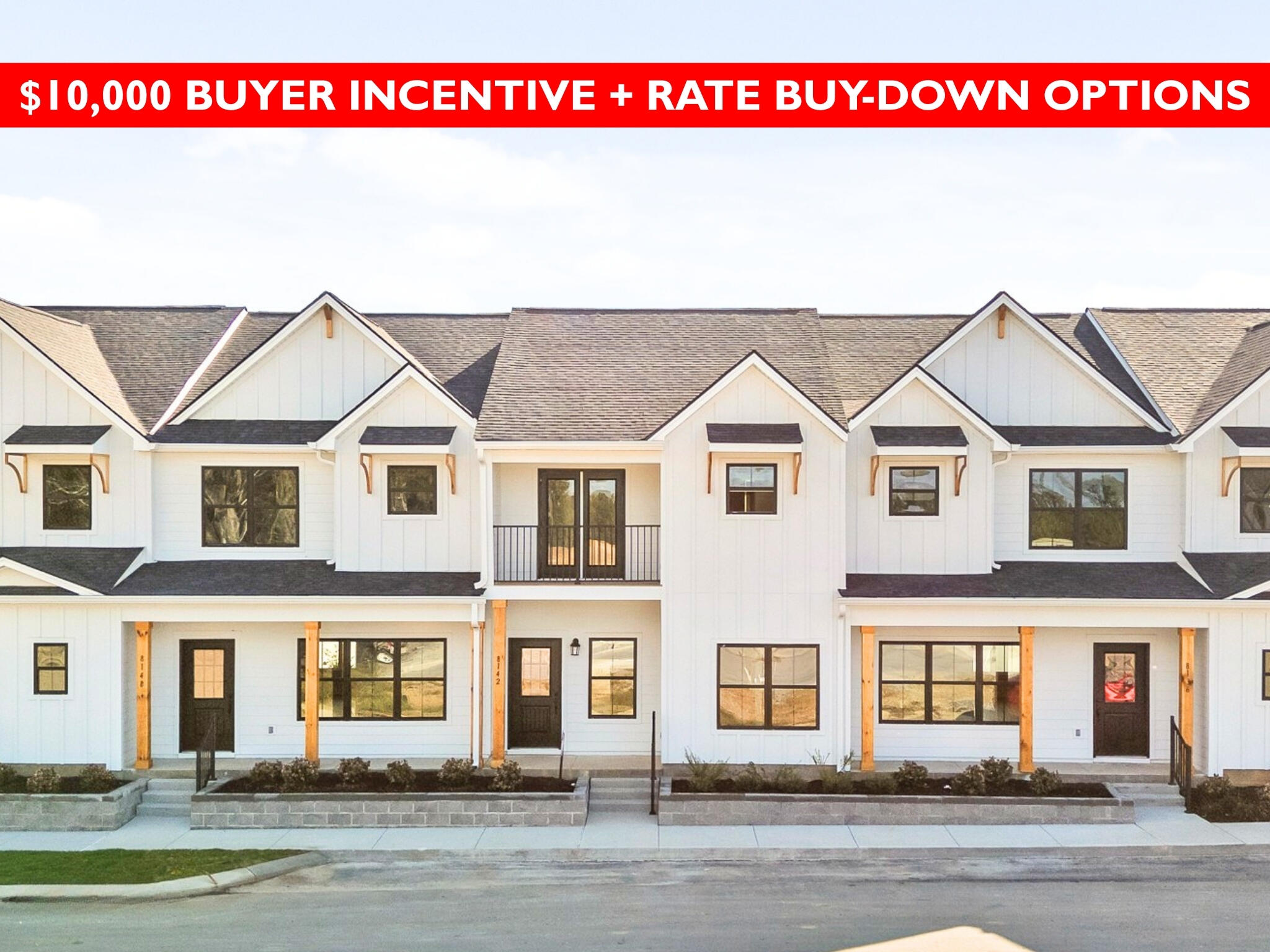 White two-story townhomes with covered porches and a banner advertising a $10,000 buyer incentive.