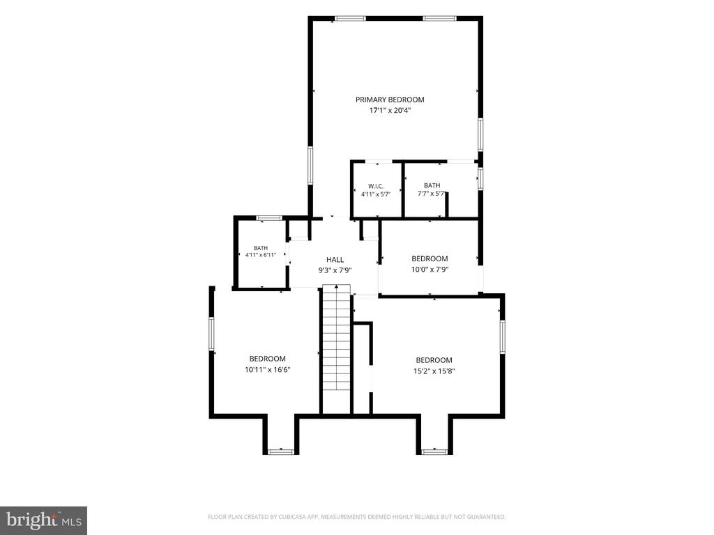 Floor plan with a primary suite, three additional bedrooms, two baths, hall, and central staircase.