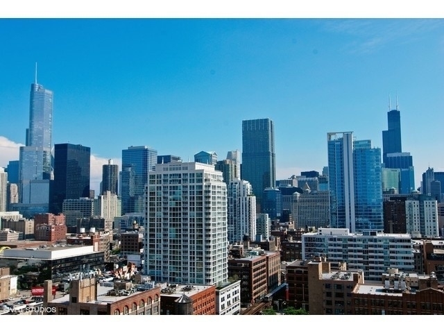 Chicago skyline with downtown skyscrapers under a clear blue sky.