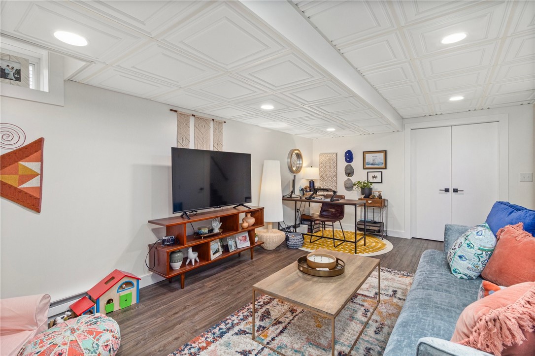 Living room with a coffered ceiling, TV area, sofa, and desk nook.