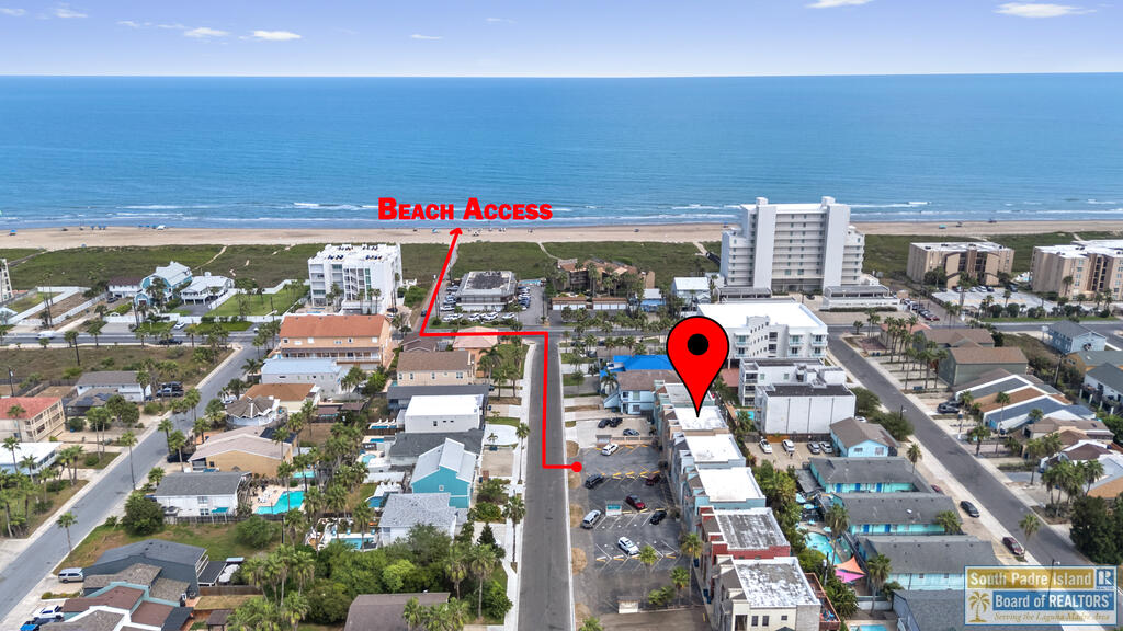 Aerial view of the property area, marked with a red pin and route to beach access.
